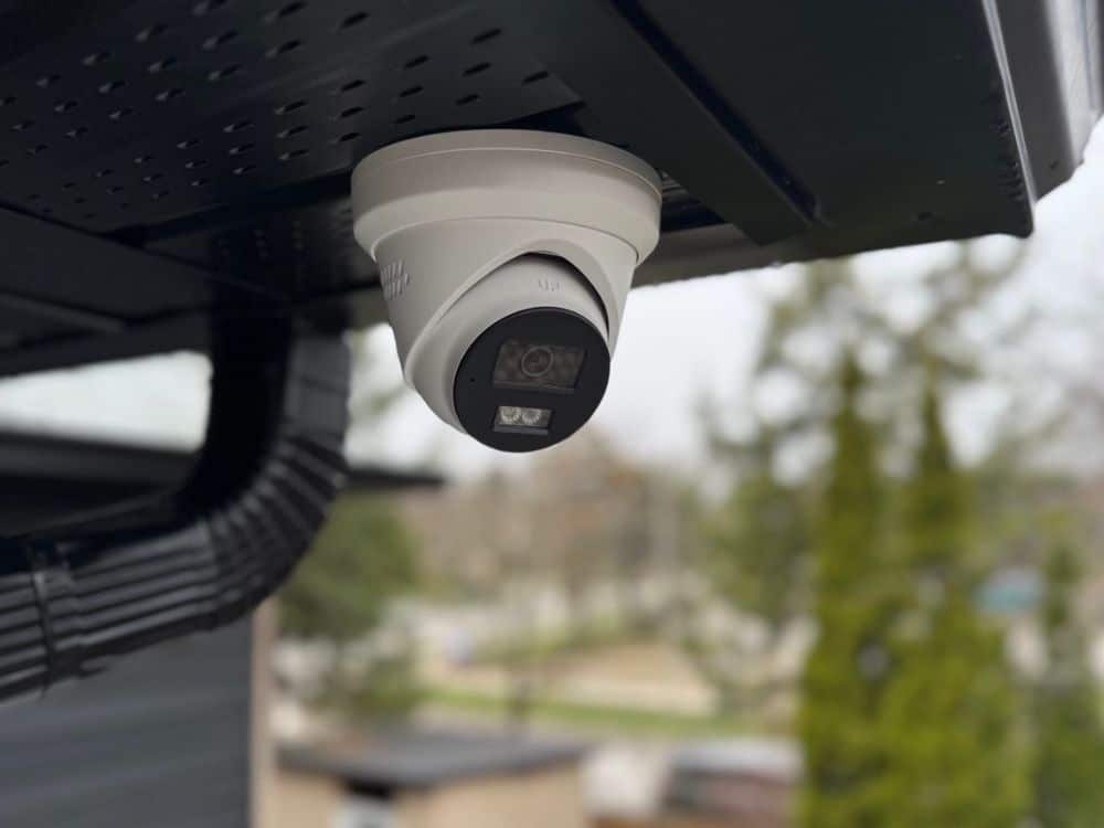 Alarmto technician adjusting a security camera angle during installation in Toronto