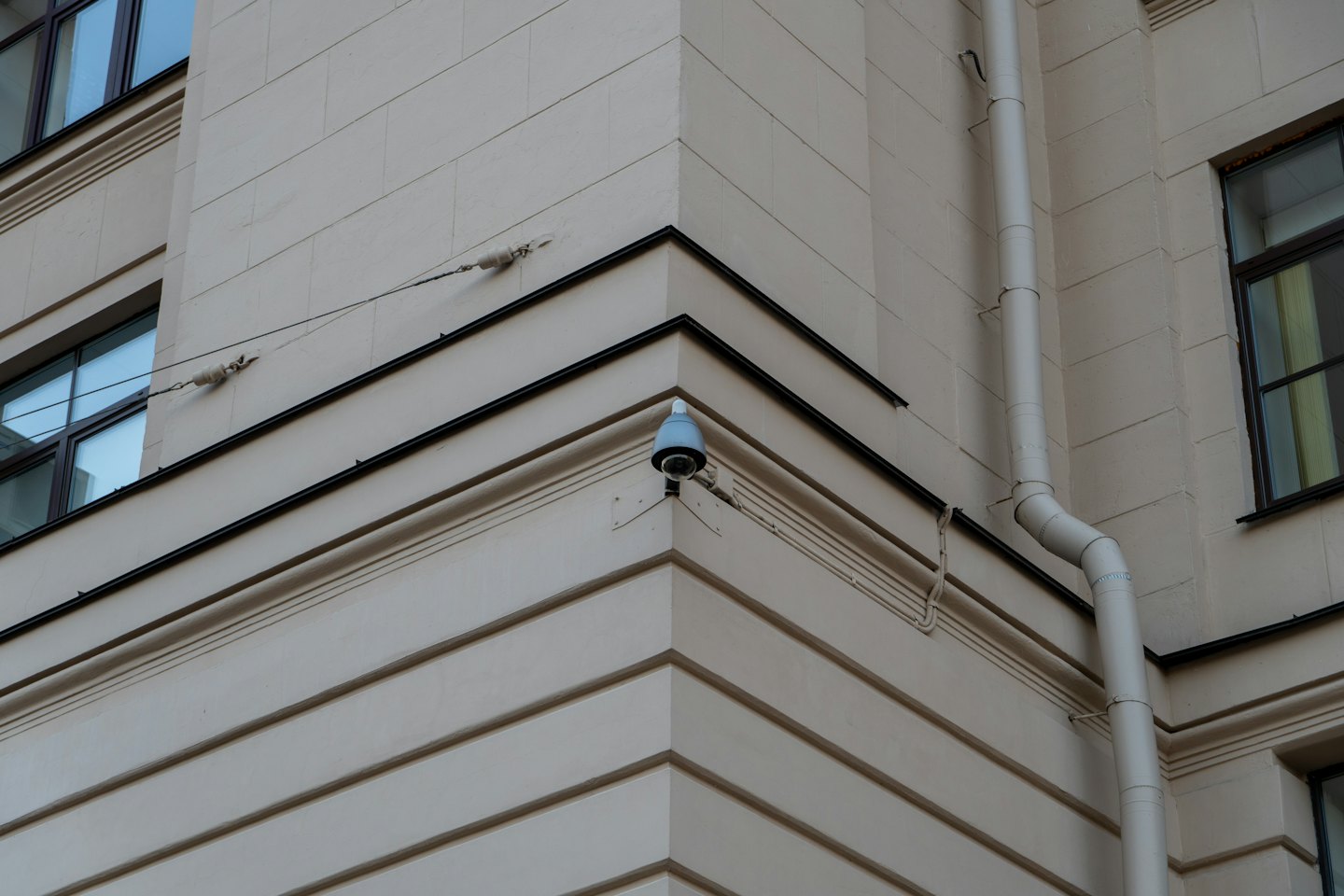 Security camera mounted on the corner of a modern building.