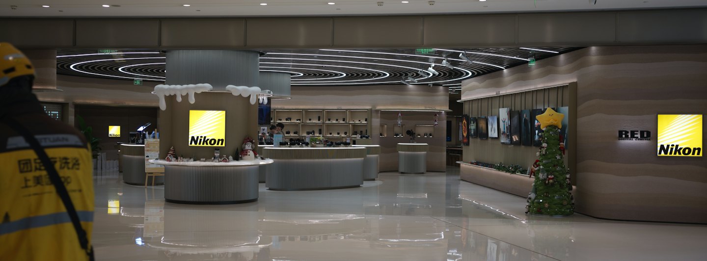 Modern camera store with display counters and Nikon logos.