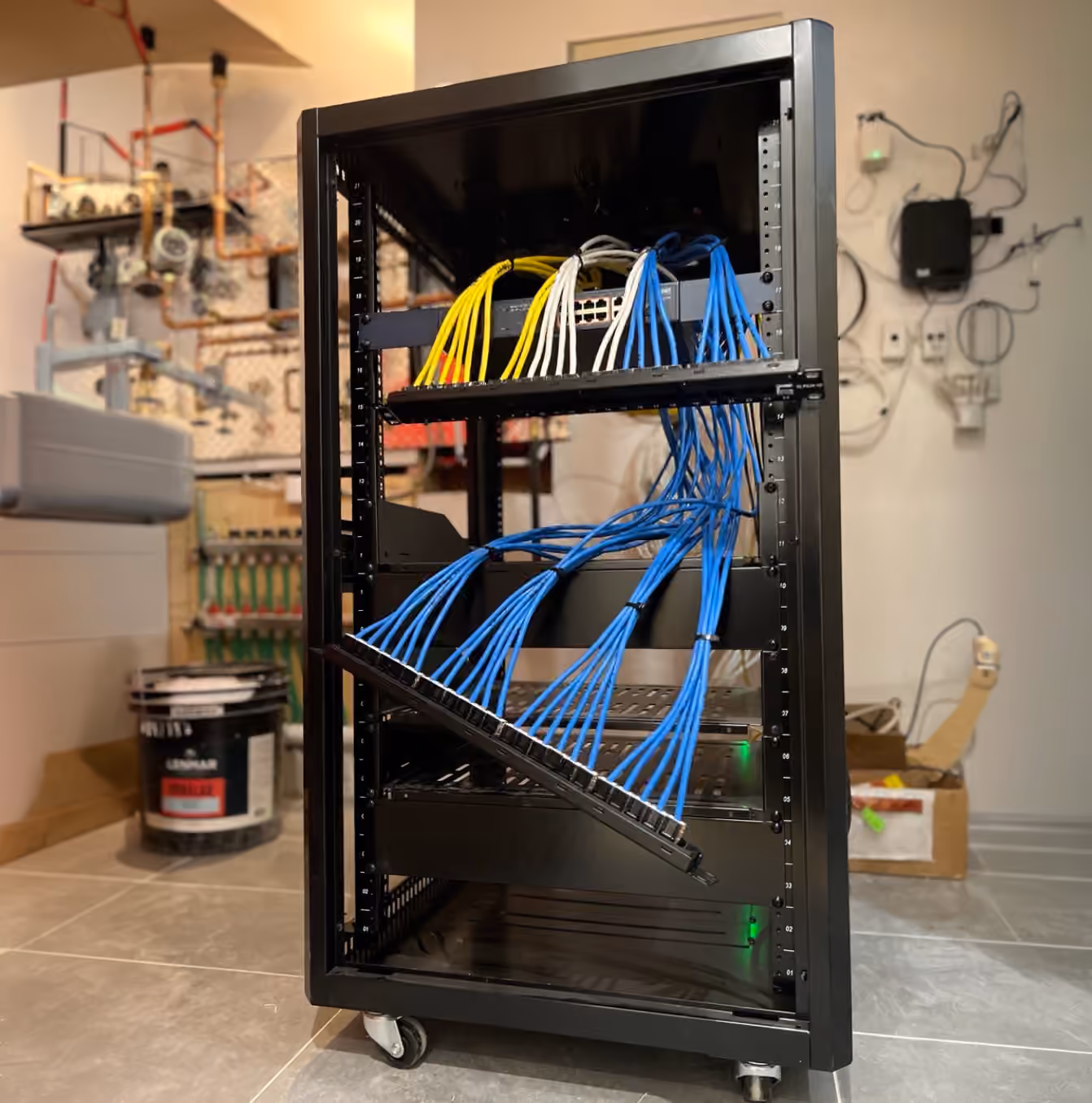Residential network cabinet with an organized router, Ethernet switch, and patch panel