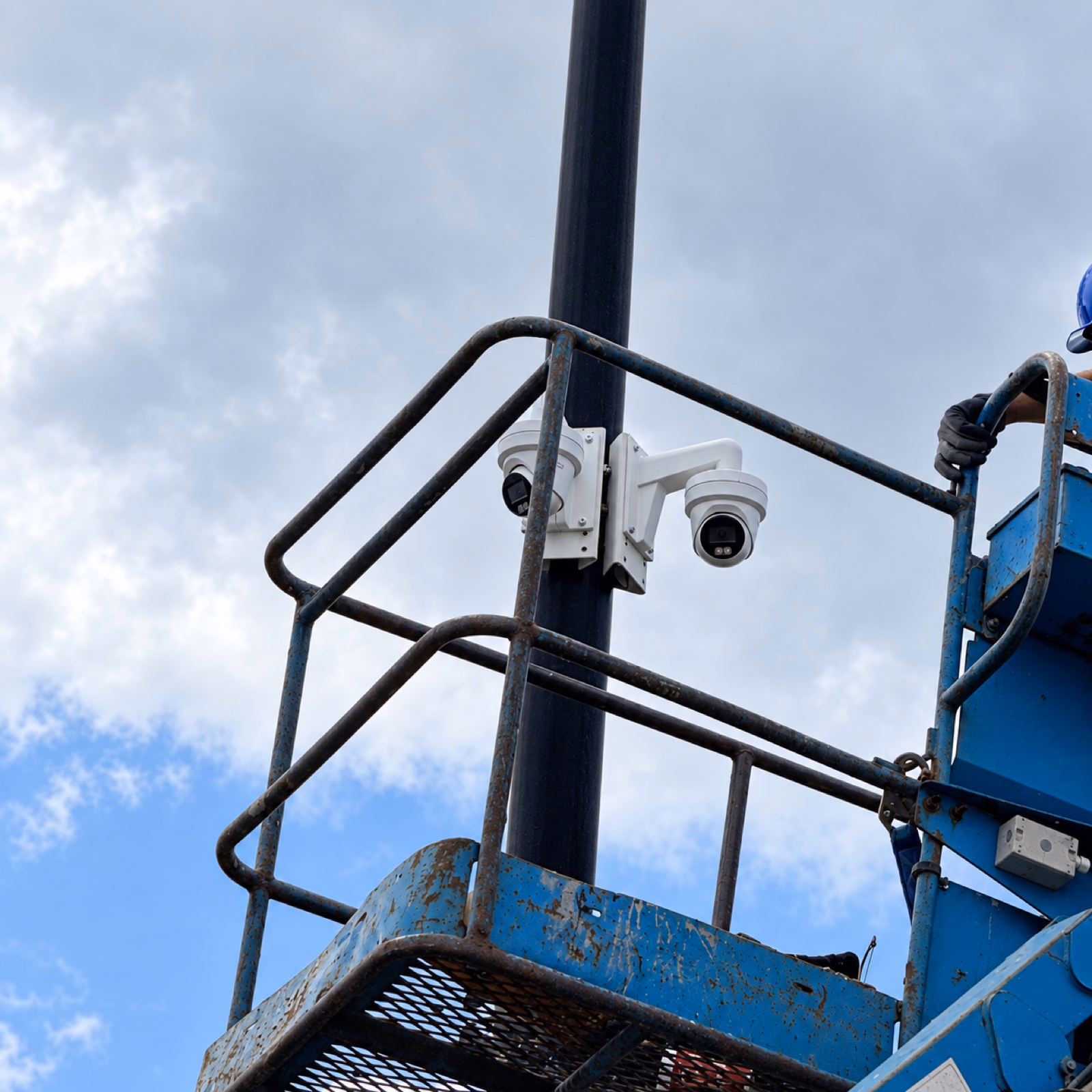 Security cameras being installed on a pole from a boom lift in Oakville