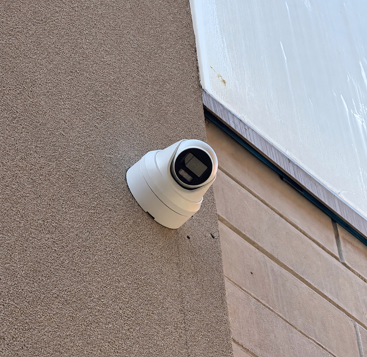 Exterior security camera mounted on a building