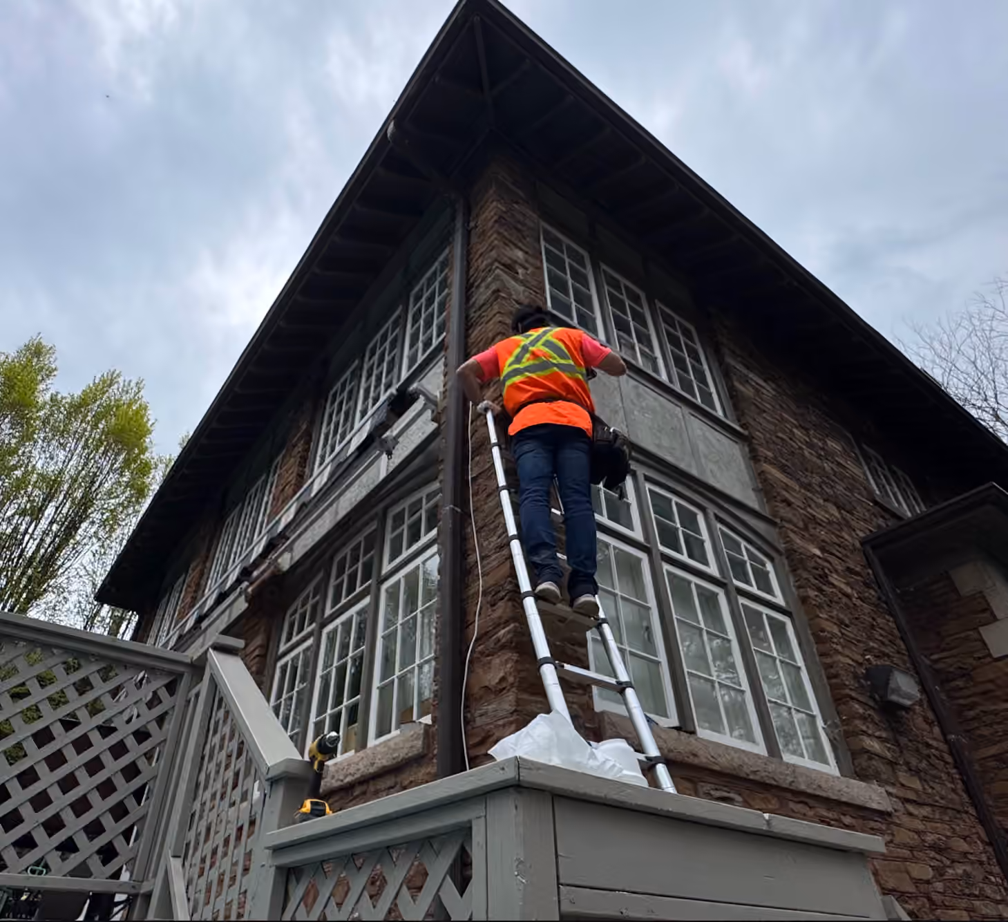 Technician assessing entry points during a home security consultation