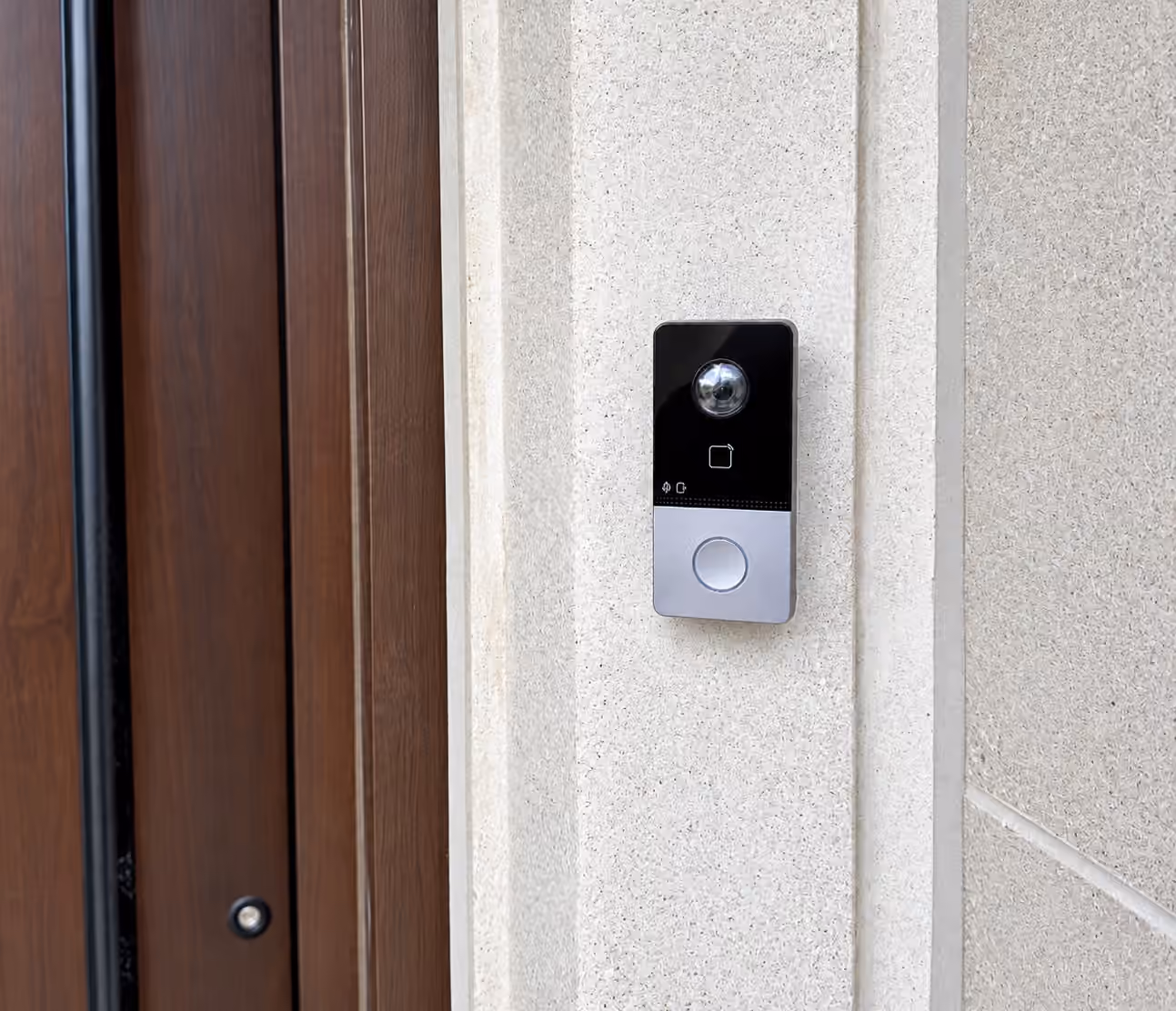 Video doorbell mounted beside a front entrance