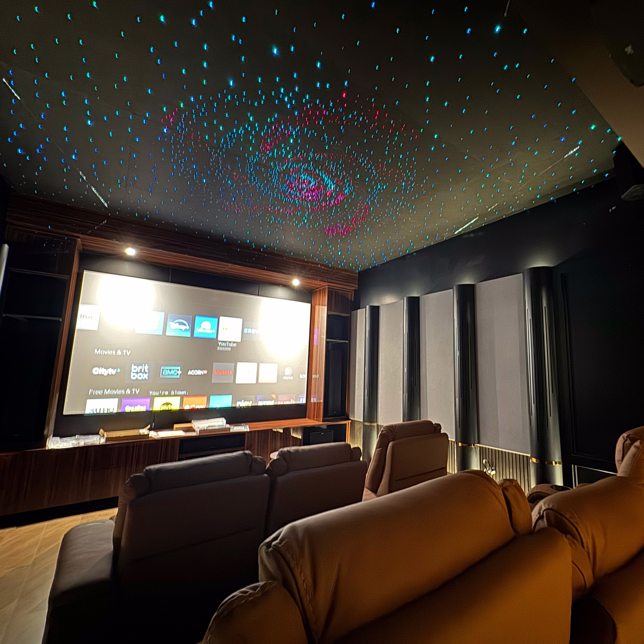 Home theatre with a star ceiling, projection screen and seating