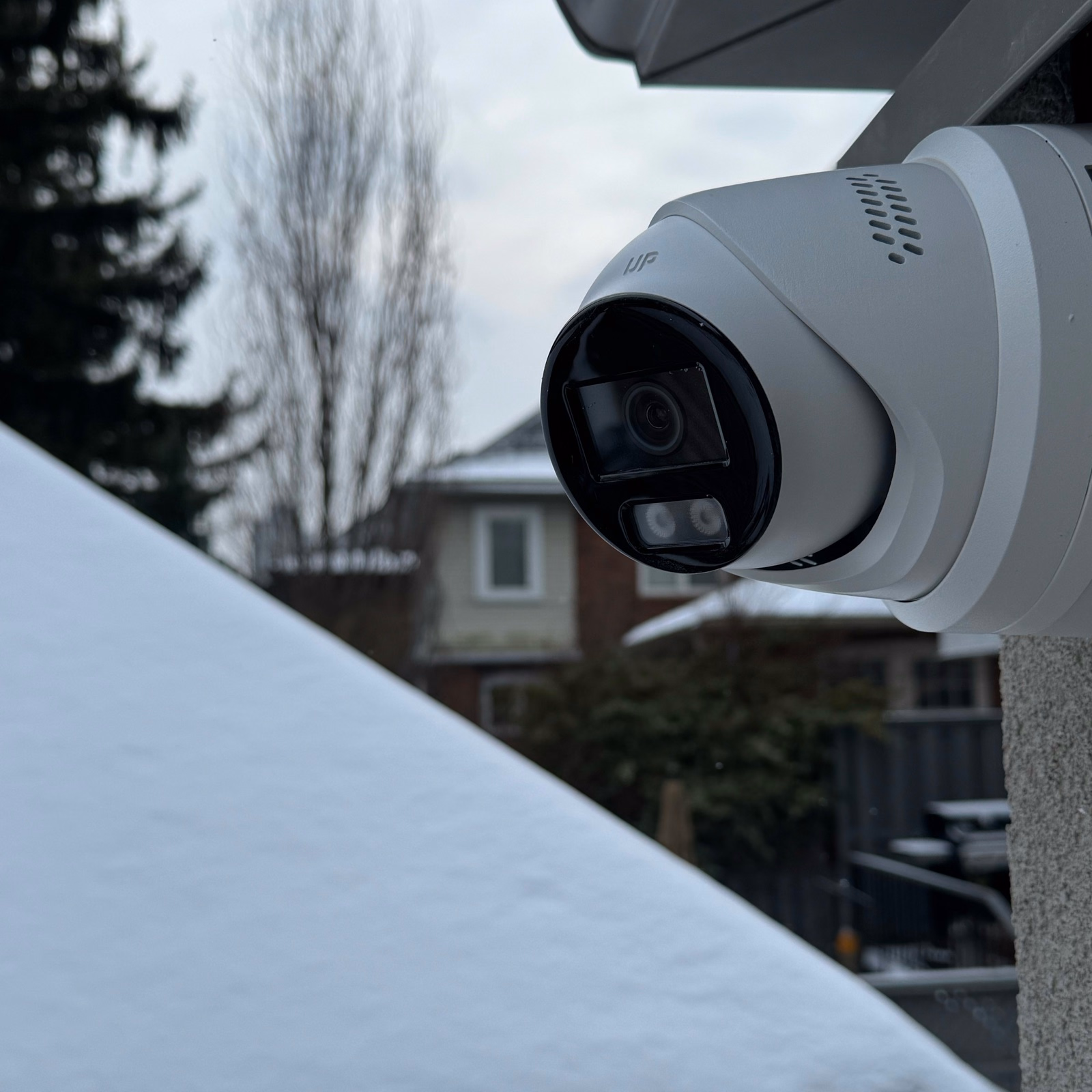 White security camera beneath a house soffit in Vaughan in winter